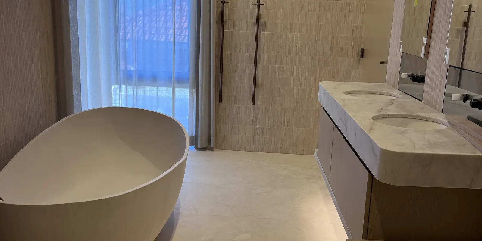Completed Canberra bathroom with a tiled floor, freestanding bath and double vanity.